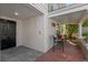 Charming patio featuring a black door, seating area, brick flooring and wall, and a tranquil outdoor space at 525 Sheridan Blvd, Orlando, FL 32804