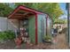 A garden shed offers storage, complemented by potted plants and greenery at 525 Sheridan Blvd, Orlando, FL 32804