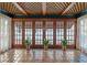 Bright sun room with tile floors, lattice ceiling, and folding doors at 525 Sheridan Blvd, Orlando, FL 32804