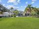 Expansive backyard with a large manicured lawn, pool, and patio seating area perfect for entertaining at 6137 Grosvenor Shore Dr, Windermere, FL 34786