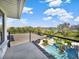 Balcony overlooking pool, lake, and lush landscaping at 6137 Grosvenor Shore Dr, Windermere, FL 34786