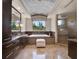 Elegant bathroom with marble floors, dark wood cabinets, and a soaking tub with window views at 6137 Grosvenor Shore Dr, Windermere, FL 34786