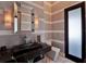 Contemporary bathroom with patterned walls, a dark marble countertop, and unique fixtures at 6137 Grosvenor Shore Dr, Windermere, FL 34786