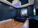 Modern bedroom with a sleek bed frame, hardwood floors, and bright, natural lighting at 6137 Grosvenor Shore Dr, Windermere, FL 34786