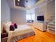 This bedroom has wood floors, a ceiling fan, and a window seat at 6137 Grosvenor Shore Dr, Windermere, FL 34786