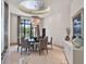 Bright dining room with a modern chandelier and large windows, perfect for elegant dinners at 6137 Grosvenor Shore Dr, Windermere, FL 34786