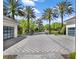 Long driveway leading to home featuring multiple garage bays and water features at 6137 Grosvenor Shore Dr, Windermere, FL 34786