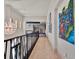 Hallway featuring modern light fixtures, decorative wall art, and unique architectural details at 6137 Grosvenor Shore Dr, Windermere, FL 34786