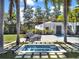 A luxurious hot tub surrounded by palm trees and lounge chairs, perfect for relaxing outdoors at 6137 Grosvenor Shore Dr, Windermere, FL 34786