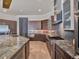 Open kitchen with stainless steel appliances, stone countertops, and a large island at 6137 Grosvenor Shore Dr, Windermere, FL 34786