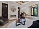 Luxurious living room with high ceilings, fireplace, statement mirror, and grand staircase at 6137 Grosvenor Shore Dr, Windermere, FL 34786