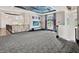 Spacious loft area with plush carpet, decorative lighting, and scenic outdoor views at 6137 Grosvenor Shore Dr, Windermere, FL 34786