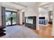 Open-concept main bedroom with a fireplace, hardwood floors, and a view to the outside deck at 6137 Grosvenor Shore Dr, Windermere, FL 34786