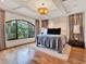 Bright main bedroom with hardwood floors, a large arched window, and neutral decor at 6137 Grosvenor Shore Dr, Windermere, FL 34786
