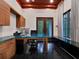 Modern home office featuring custom built-ins, a unique glass desktop, dark hardwood floors, and natural lighting at 6137 Grosvenor Shore Dr, Windermere, FL 34786