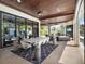 Covered outdoor dining area with wood ceiling and great views of the backyard at 6137 Grosvenor Shore Dr, Windermere, FL 34786