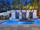 Night view of the pool and pool house featuring stylish design and lighting at 6137 Grosvenor Shore Dr, Windermere, FL 34786