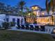 Night view of the modern backyard pool area and house with landscape lighting at 6137 Grosvenor Shore Dr, Windermere, FL 34786