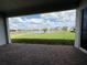 Covered patio offers stunning views of the lake and well-maintained backyard at 8243 Fenton St, Orlando, FL 32836