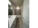 Well-lit bathroom with tiled shower over tub and modern vanity with quartz countertop at 8243 Fenton St, Orlando, FL 32836