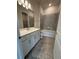Full bathroom showcasing a tub with tile surround and white vanity with ample storage at 8243 Fenton St, Orlando, FL 32836