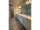 Bathroom features double vanity with modern fixtures, stylish tile flooring, and great lighting at 8243 Fenton St, Orlando, FL 32836