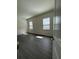 Bedroom with two windows, blinds, and hardwood floors bringing in natural light at 8243 Fenton St, Orlando, FL 32836