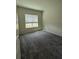 Carpeted bedroom with natural light from a window and neutral wall paint at 8243 Fenton St, Orlando, FL 32836