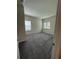 Bright bedroom with neutral walls and plush carpet, and windows offering natural light at 8243 Fenton St, Orlando, FL 32836