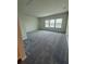 Spacious bedroom with three windows and neutral walls, providing ample natural light at 8243 Fenton St, Orlando, FL 32836
