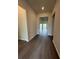Inviting hallway boasts sleek wood-look flooring and neutral paint, leading to living spaces at 8243 Fenton St, Orlando, FL 32836