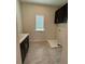 Laundry room with dark cabinets, a sink, and a window for natural light at 8243 Fenton St, Orlando, FL 32836