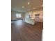 Bright living space includes a modern kitchen with an island and pendant lighting at 8243 Fenton St, Orlando, FL 32836