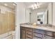Well-lit bathroom featuring dual sinks and a large mirror with glass shower at 8840 Bengal Ct, Kissimmee, FL 34747