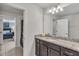 Modern bathroom with granite countertop, undermount sink, and view into adjacent bedroom at 8840 Bengal Ct, Kissimmee, FL 34747