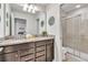 Stylish bathroom with granite countertops, double sinks, and a glass-enclosed shower at 8840 Bengal Ct, Kissimmee, FL 34747