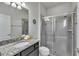 Well-lit bathroom showcasing a glass-enclosed shower and a granite vanity at 8840 Bengal Ct, Kissimmee, FL 34747