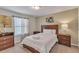 Comfortable bedroom featuring a wooden bed frame, matching nightstands, and neutral decor at 8840 Bengal Ct, Kissimmee, FL 34747