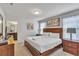 Bedroom with a wood-framed bed and two nightstands next to an ensuite bathroom at 8840 Bengal Ct, Kissimmee, FL 34747