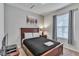 Comfortable bedroom features a wood-framed bed, soft lighting, and a large window at 8840 Bengal Ct, Kissimmee, FL 34747