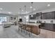 Open-concept kitchen features a large island, stainless steel appliances, and stylish pendant lighting at 8840 Bengal Ct, Kissimmee, FL 34747
