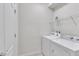 Bright laundry room with white washer and dryer, storage shelf, and white door at 8840 Bengal Ct, Kissimmee, FL 34747