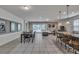Expansive living area features a dining table, comfortable seating, and stylish decor with sliding glass doors to the pool at 8840 Bengal Ct, Kissimmee, FL 34747
