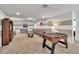 Large living room offering a comfortable seating area and a foosball table at 8840 Bengal Ct, Kissimmee, FL 34747