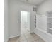 Clean mudroom with tile flooring, built-in bench, and storage shelves at 8840 Bengal Ct, Kissimmee, FL 34747