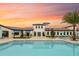 Community clubhouse pool with lounge chairs, umbrellas, and landscaped walkway at 8840 Bengal Ct, Kissimmee, FL 34747