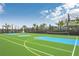 Community sports court featuring basketball hoops and tennis net on bright green surface at 8840 Bengal Ct, Kissimmee, FL 34747