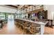 This stylish bar features seating, shelving, a TV, and decor, providing a space for relaxation at 9004 Sunshine Ridge Loop, Kissimmee, FL 34747