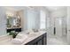 Bright bathroom featuring a vanity, glass-enclosed shower, and ample counter space at 9004 Sunshine Ridge Loop, Kissimmee, FL 34747