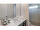 Bright bathroom with a large vanity, white towels and a shower with striped curtain at 9004 Sunshine Ridge Loop, Kissimmee, FL 34747